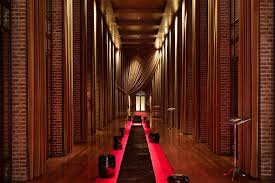 Luxurious hallway with warm lighting and rich wood paneling.