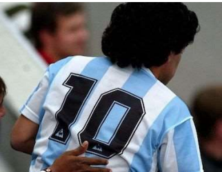Soccer player wearing jersey number 10 in a light blue and white striped uniform.